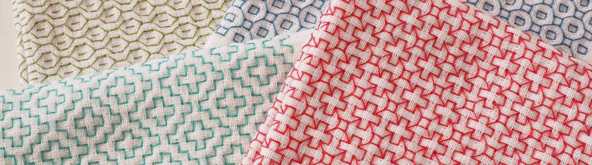 Balls of multicoloured embroidery thread in close-up, lined up side by side