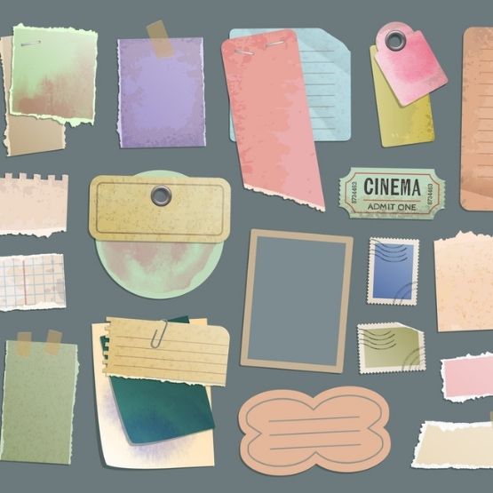Collection of coloured papers, labels and decorative scrapbooking elements.