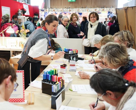 A scrapbooking workshop with participants making cards and decorations.