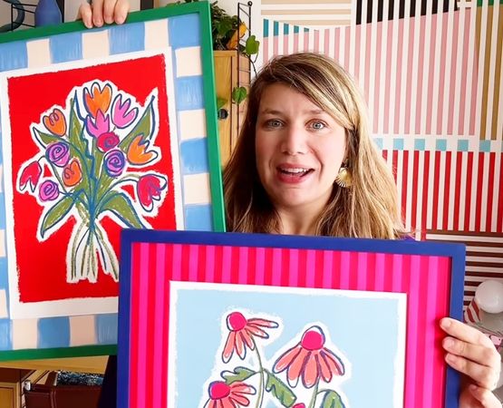Woman presenting colourful decorative frames made in an artistic DIY style
