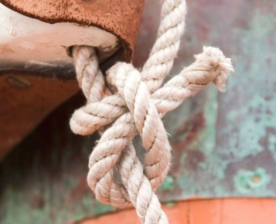 Close-up of a sailor's knot made with thick rope.