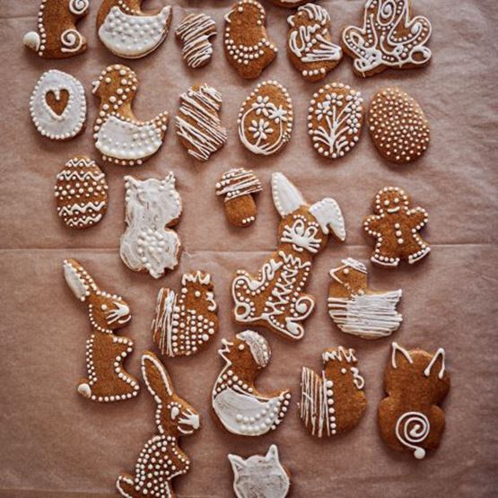 Set of Easter gingerbread biscuits decorated with white icing and featuring eggs, rabbits, chicks and ducks.