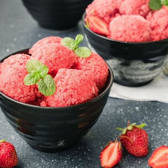 Bowls of strawberry sorbet garnished with mint leaves.