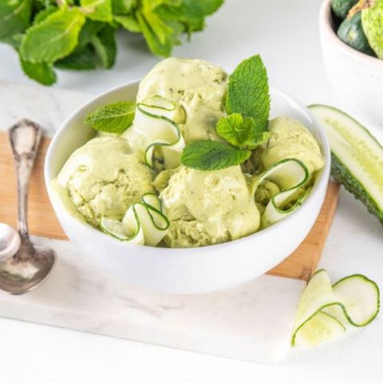 Green sorbet served in a white bowl with cucumber slices and mint.