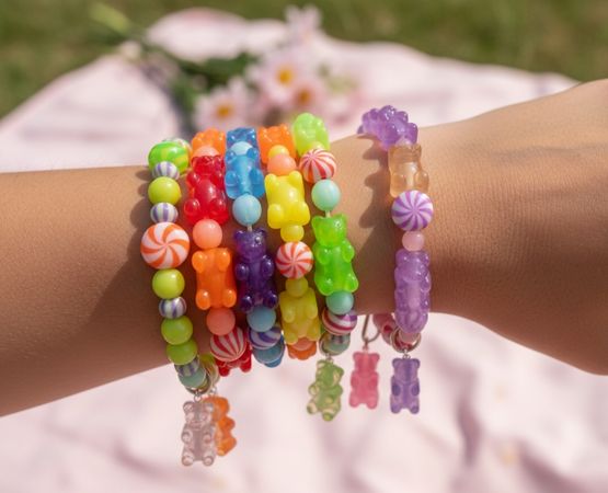 Colourful bracelets in fantasy pearls worn on the wrist for a playful, summery feel