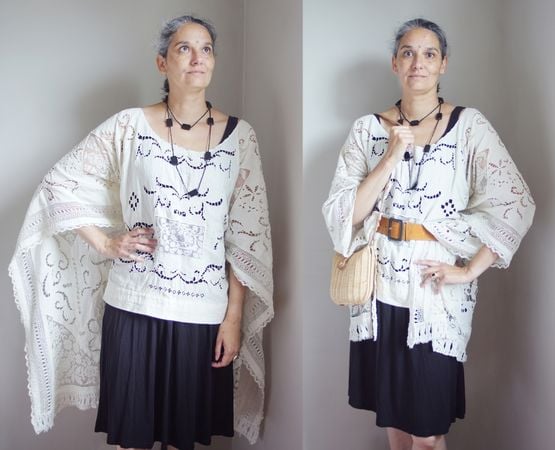 A woman wearing a white bohemian outfit with accessories