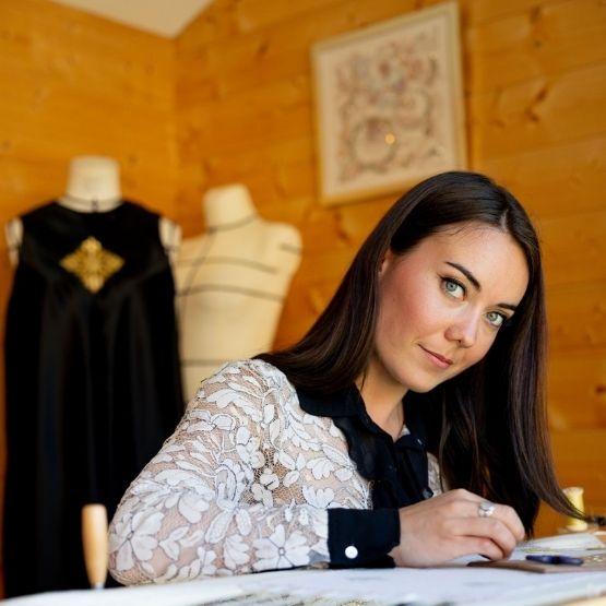 Woman working on fashion designs in her textile studio.
