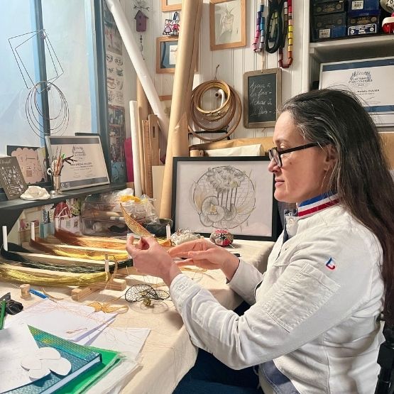 Woman in a creative workshop modelling and drawing sculptures.