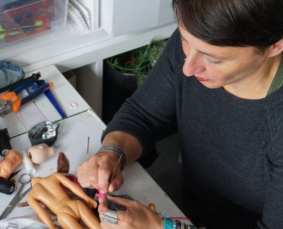 Woman creating handcrafted jewellery in her workshop.