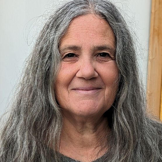 Portrait of Pascale Goldenberg, a smiling woman with long silver hair.