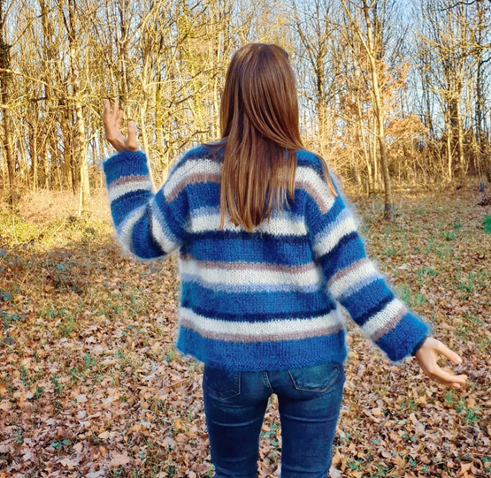 A woman with her back to a jumper