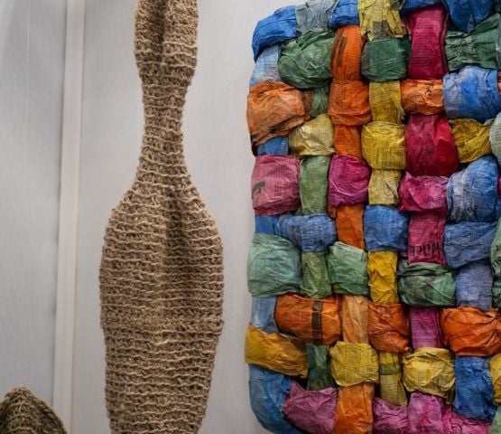 An exhibition of textile art presented at the Créations & Savoir-faire show, featuring handmade creations.