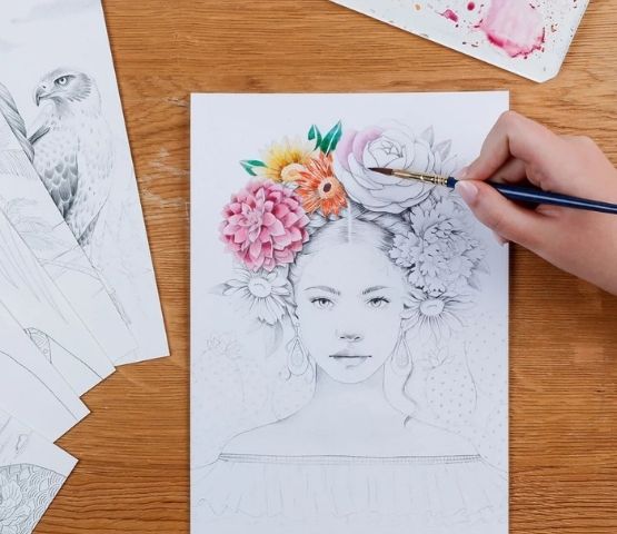 Watercolour illustration of a young woman with coloured flowers in her hair.