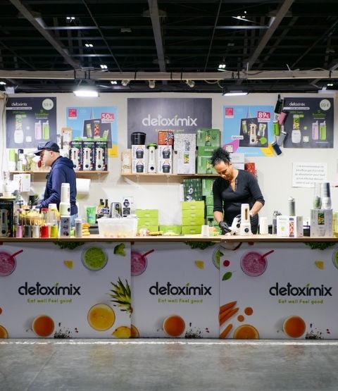 Detoximix stand with blenders and juice bottles on show.