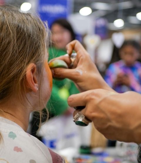 Girl getting her face made up during an animation.
