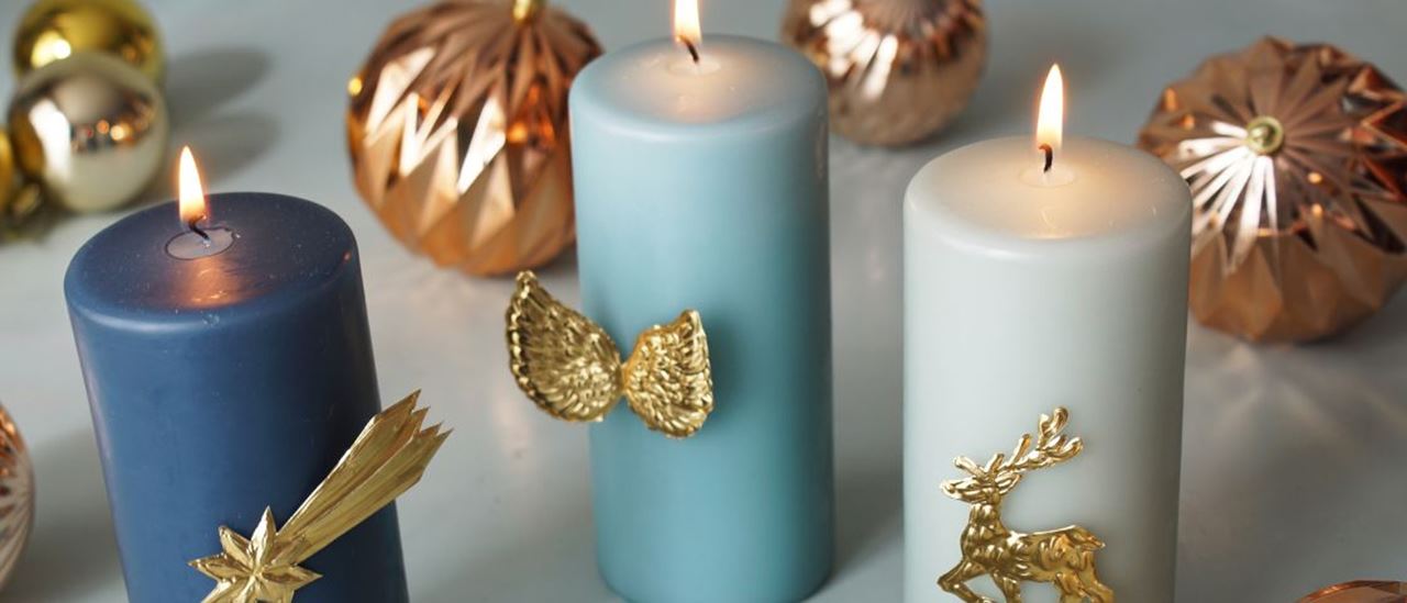 Gold jewellery on wax candles