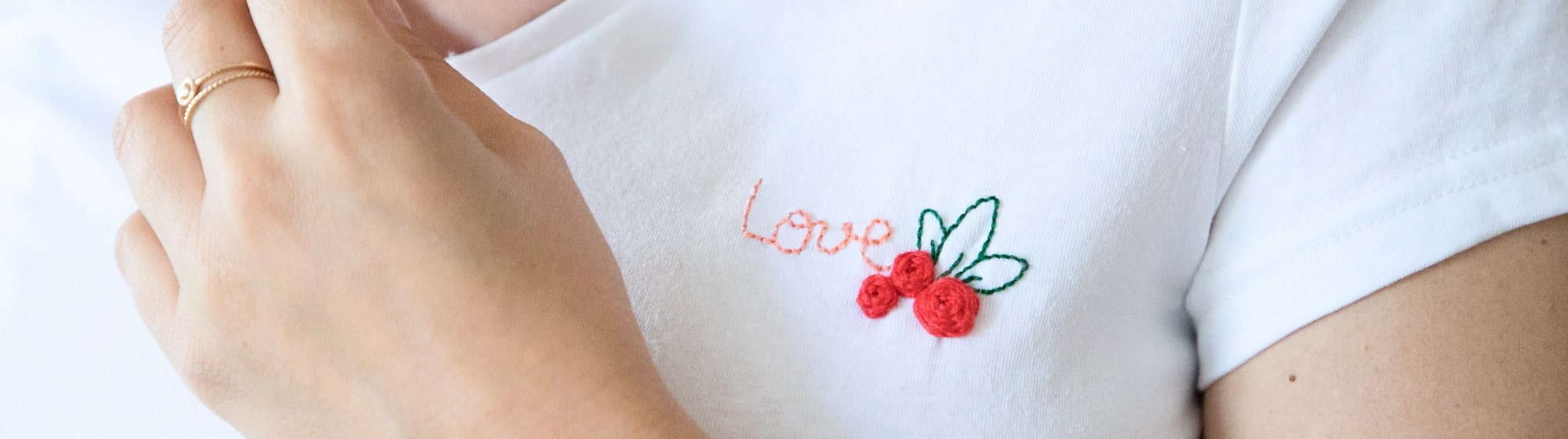 Love embroidery on white t-shirt
