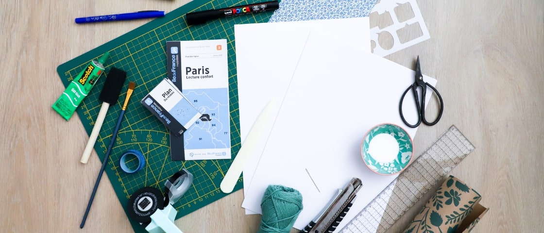 Handmade DIY travel diary materials: ball of wool, glue, scissors, paper,...