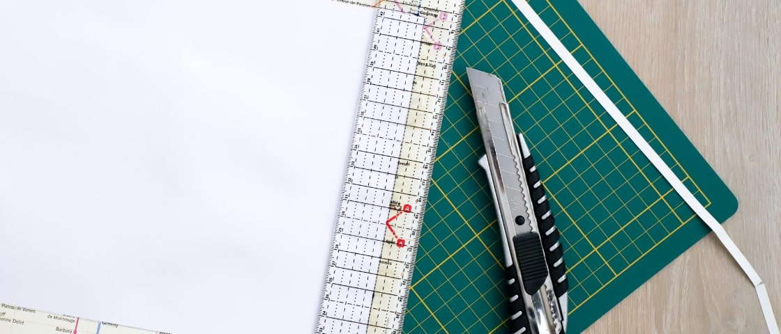 Handmade DIY travel diary materials: metro map, paper and cutter