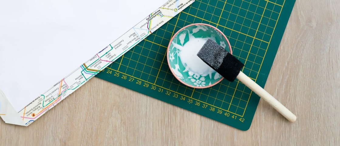 Handmade DIY travel journal materials: glue pot and brush