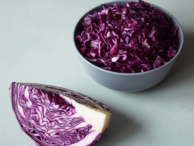 Red cabbage cut into small pieces in a bowl, ready to use for natural ink.
