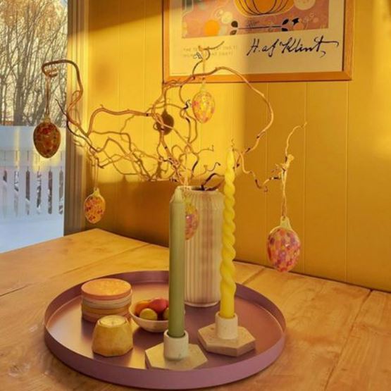 Decorating an artificial tree with Easter eggs