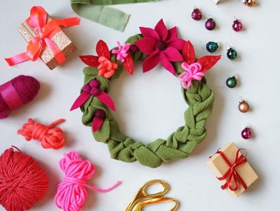 Handmade Christmas wreath with felt flowers and wool decorations.