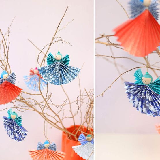 Image doubles d'anges en papier bleu et rouges avec des branches d'arbres