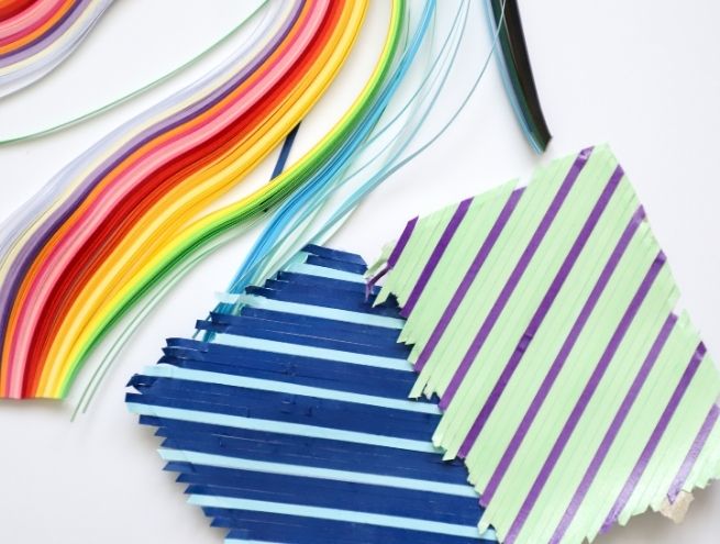 Graphic composition in strips of coloured paper for a modern DIY creation