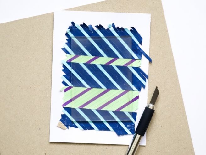 Final paper marquetry composition with coloured strips and DIY tools