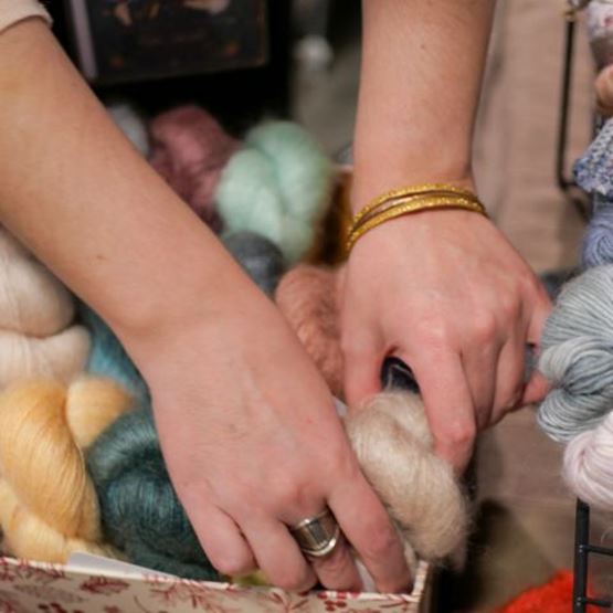 Hands in balls of wool